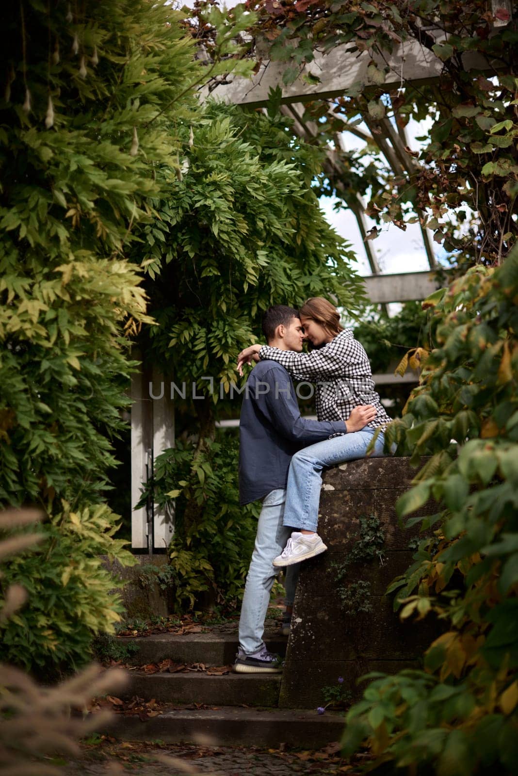 Young Cute Female Hugs Boyfriend. In Autumn Outdoor. Lovers Walking in Park. Attractive Funny Couple. Lovestory in Forest. Man and Woman. Cute Lovers in the Park. Family Concept. Happy Couple.