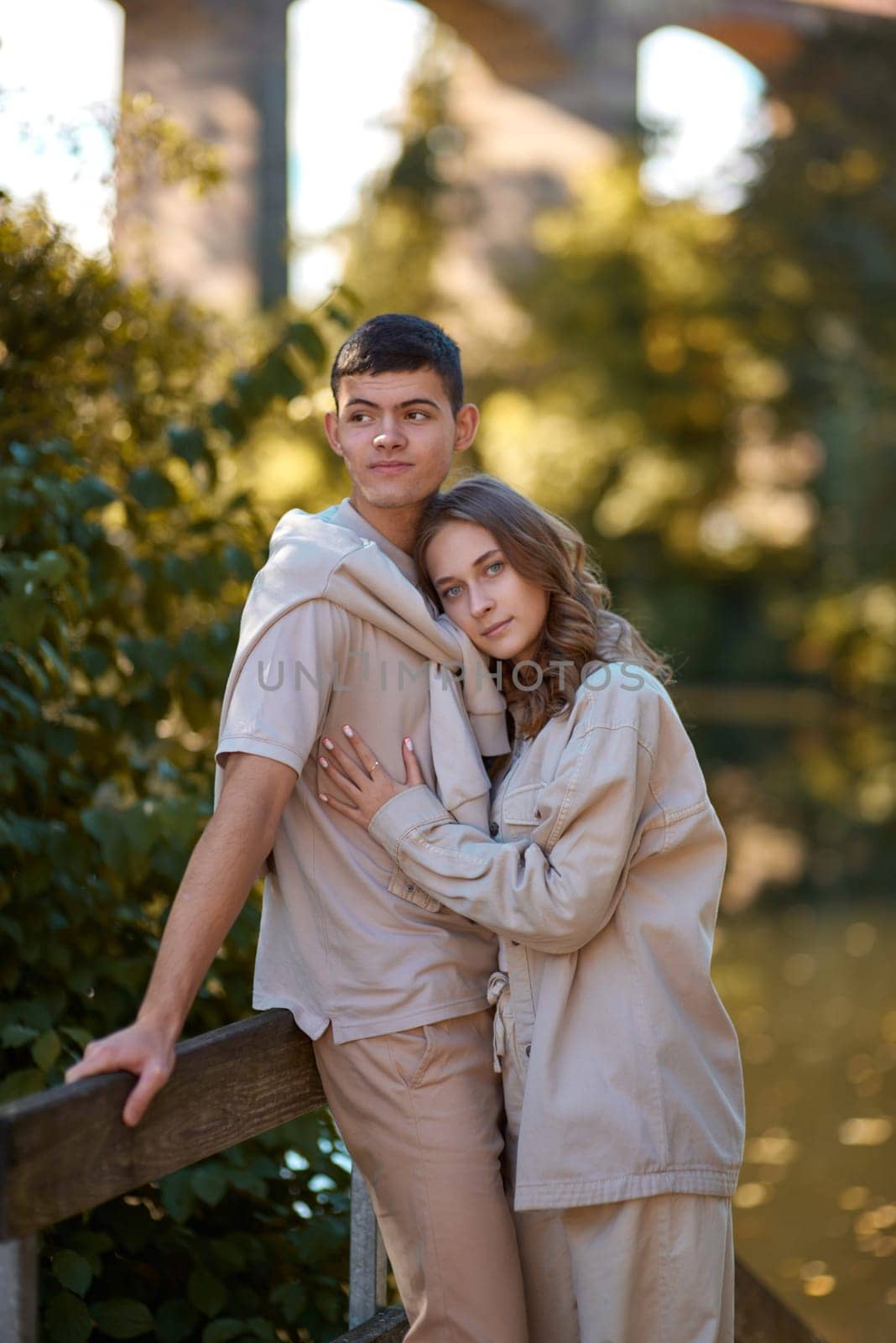 Young Cute Female Hugs Boyfriend. In Autumn Outdoor. Lovers Walking in Park. Attractive Funny Couple. Lovestory in Forest. Man and Woman. Cute Lovers in the Park. Family Concept. Happy Couple.