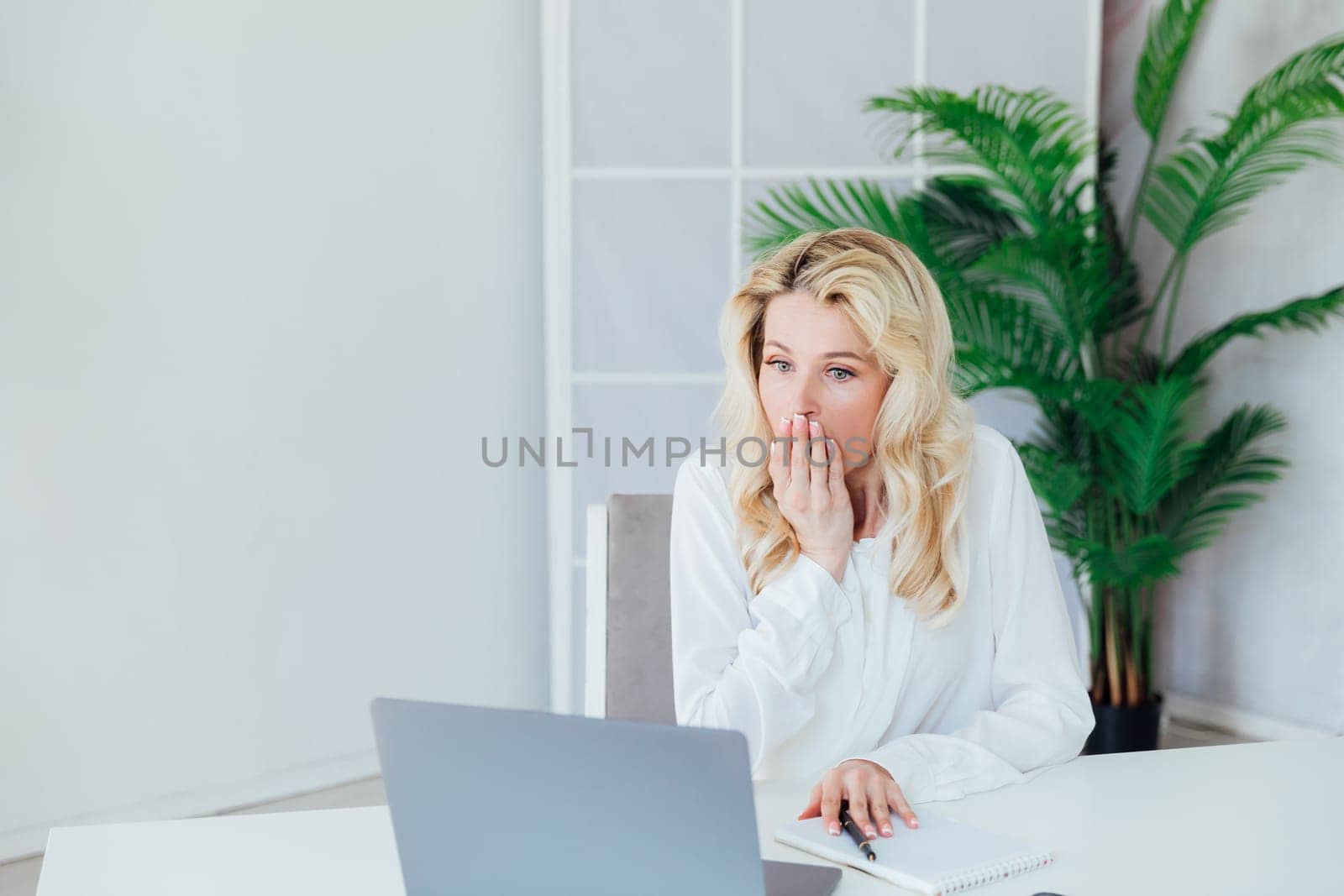 Business woman in office at laptop business online