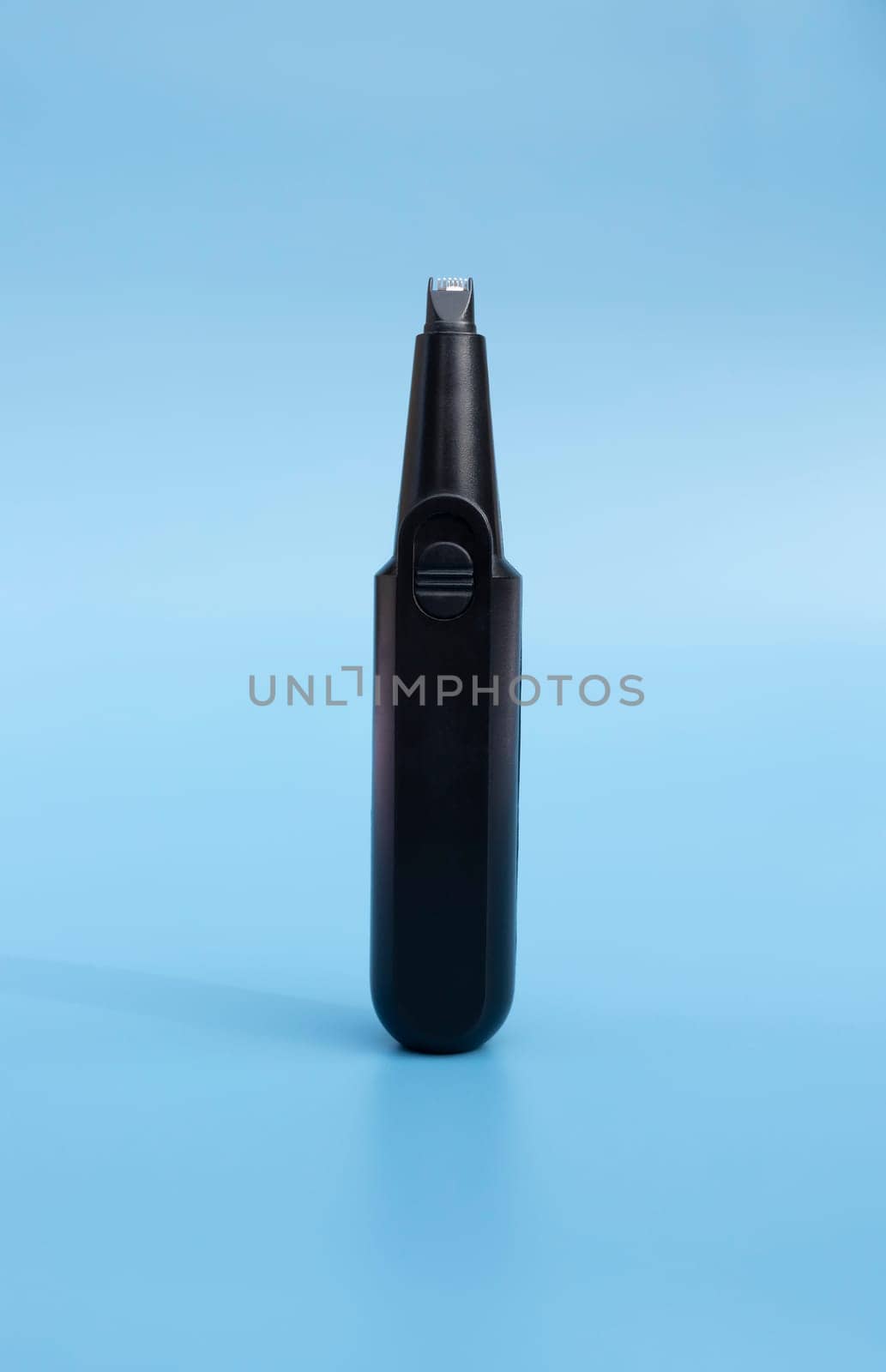 Electric Nose or Ear, Eyebrow, Facial Hair Trimmer On Blue Background. Removal Unwanted Hair Device. Personal Hygiene. Shaver, Epilator. Home Haircut Kit. Vertical Plane High quality photo