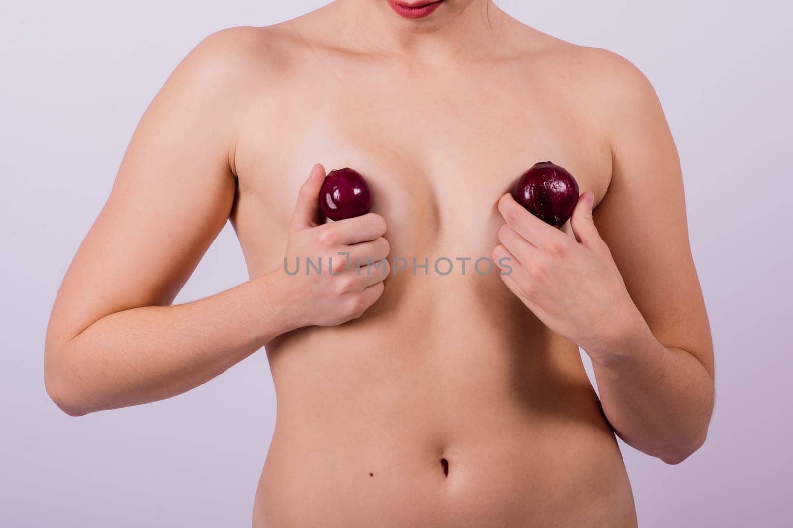 Cold, snot and flu protection, woman with an onion, white background. Female person topless