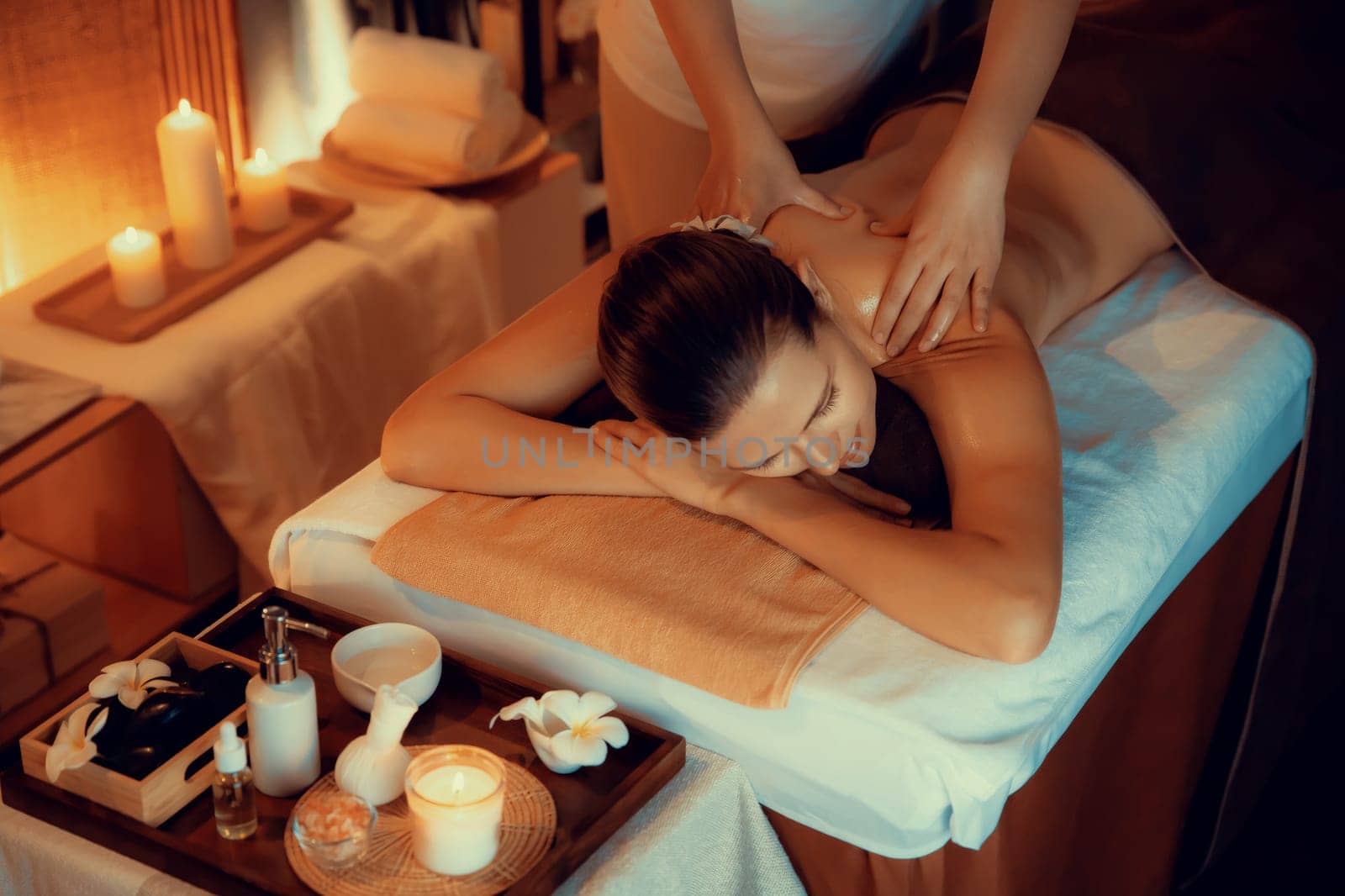 Caucasian woman customer enjoying relaxing anti-stress massage. Quiescent by biancoblue