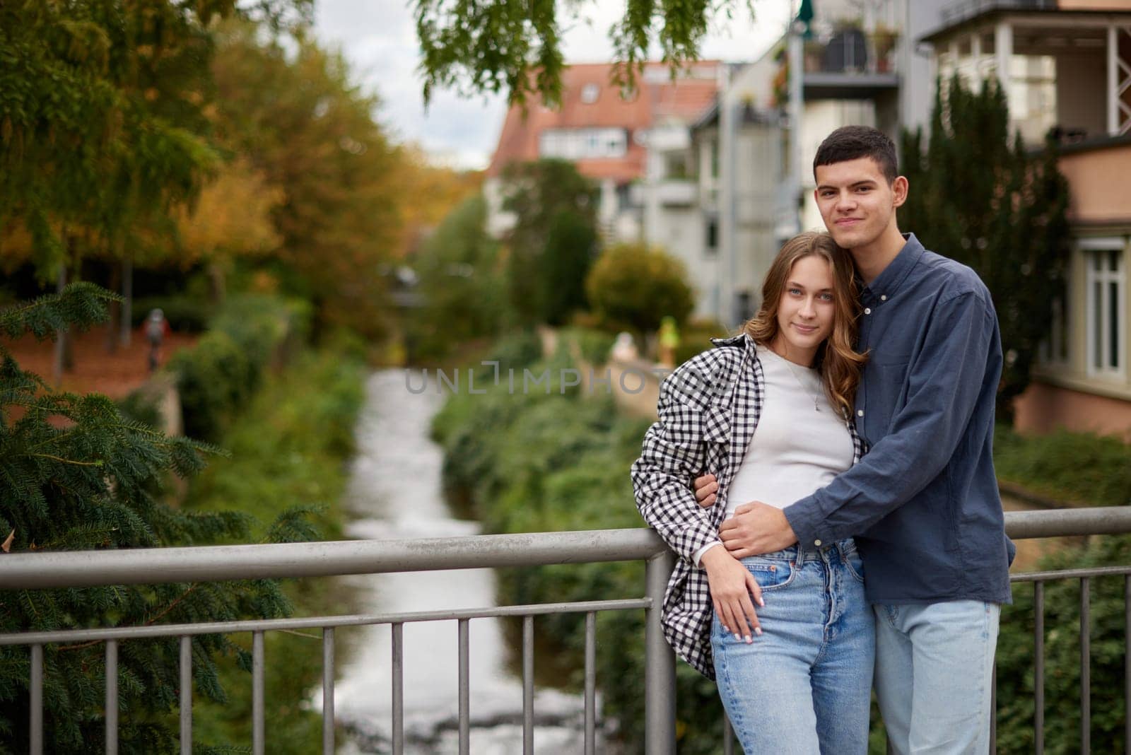 Warm Embrace of Teen Love in the Autumn Park. Capturing Teen Moments: Love Blossoms in Autumn's Embrace. Teenagers in Love: Embracing the Autumn Vibe by Andrii_Ko