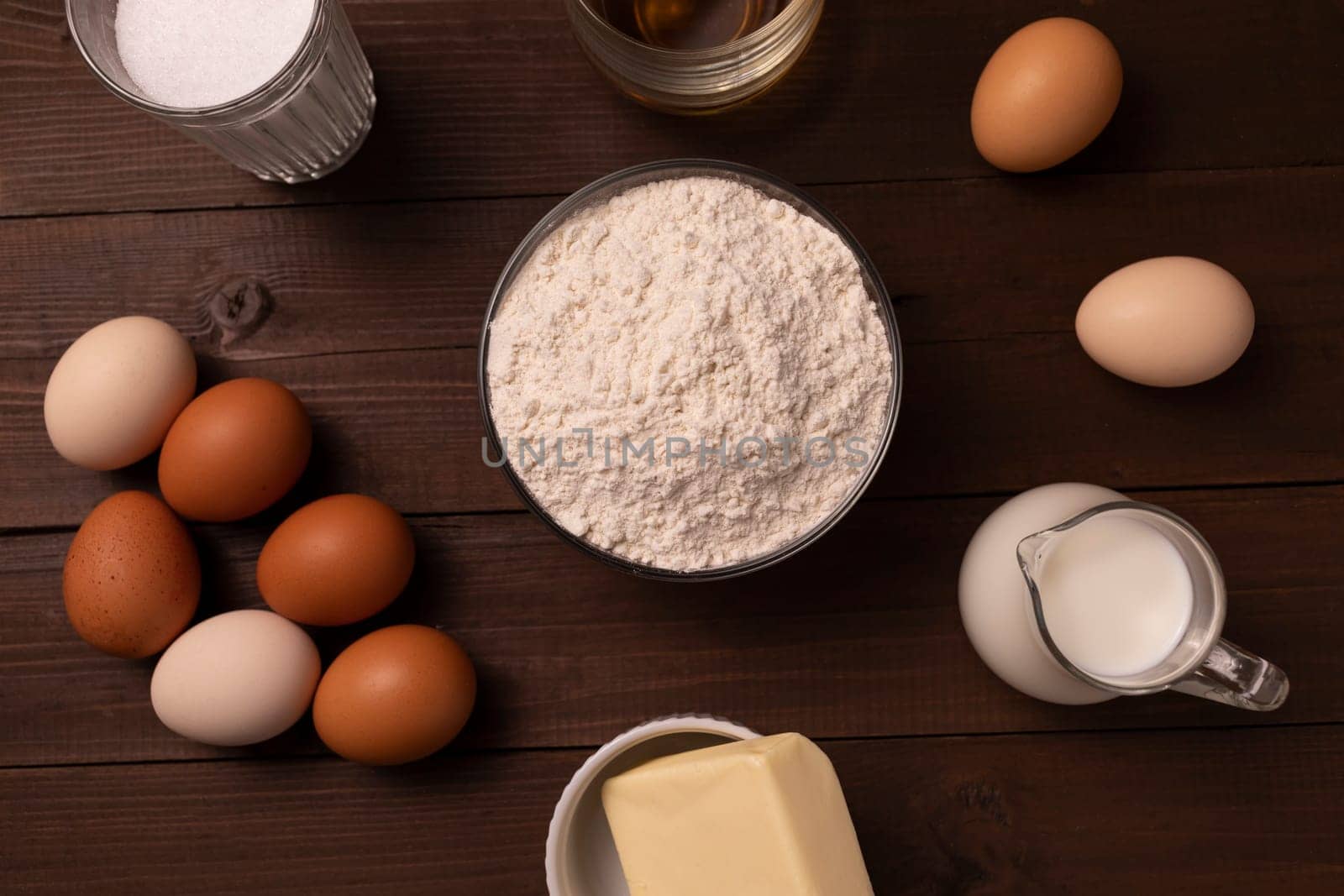 Top View Of Ingredients Wheat Flour, Eggs, Milk, Butter, Sugar, Cognac On Wooden Table For Sakotis Or Raguolis, Traditional Christmas Spit Cake. High quality photo