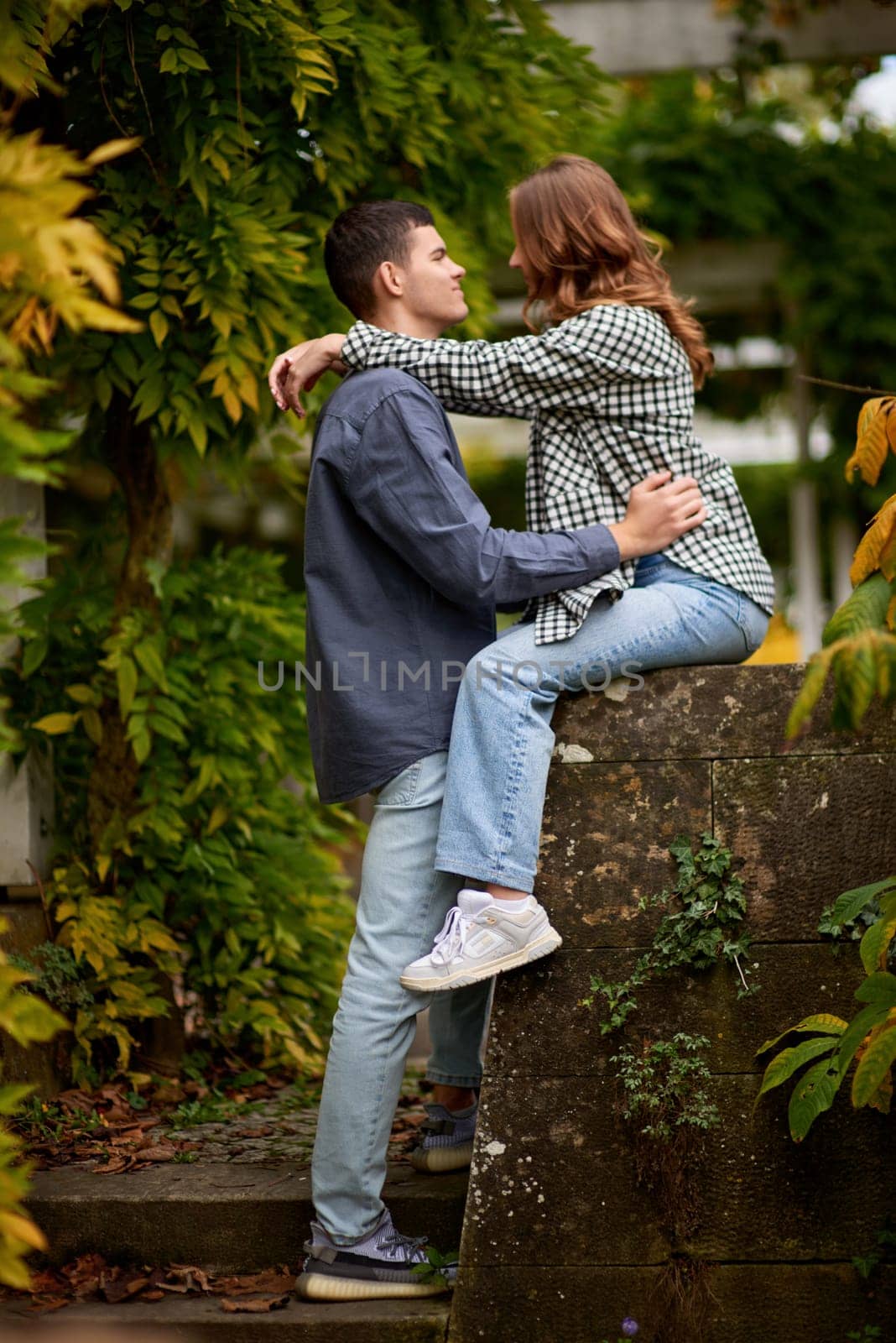 Young Cute Female Hugs Boyfriend. In Autumn Outdoor. Lovers Walking in Park. Attractive Funny Couple. Lovestory in Forest. Man and Woman. Cute Lovers in the Park. Family Concept. Happy Couple. by Andrii_Ko