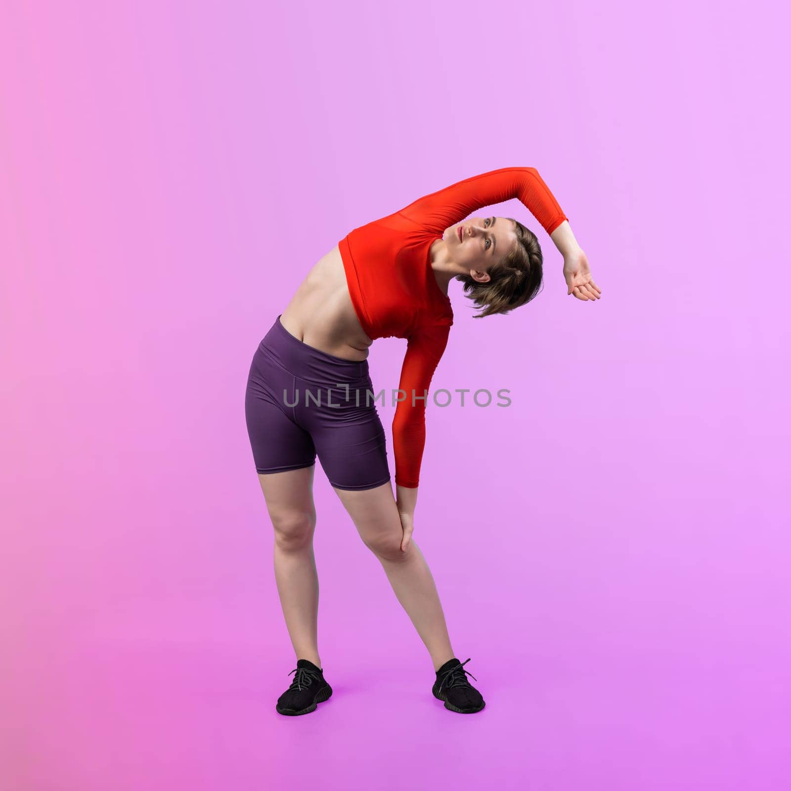 Full body length gaiety shot athletic sporty woman with warmup posture by biancoblue