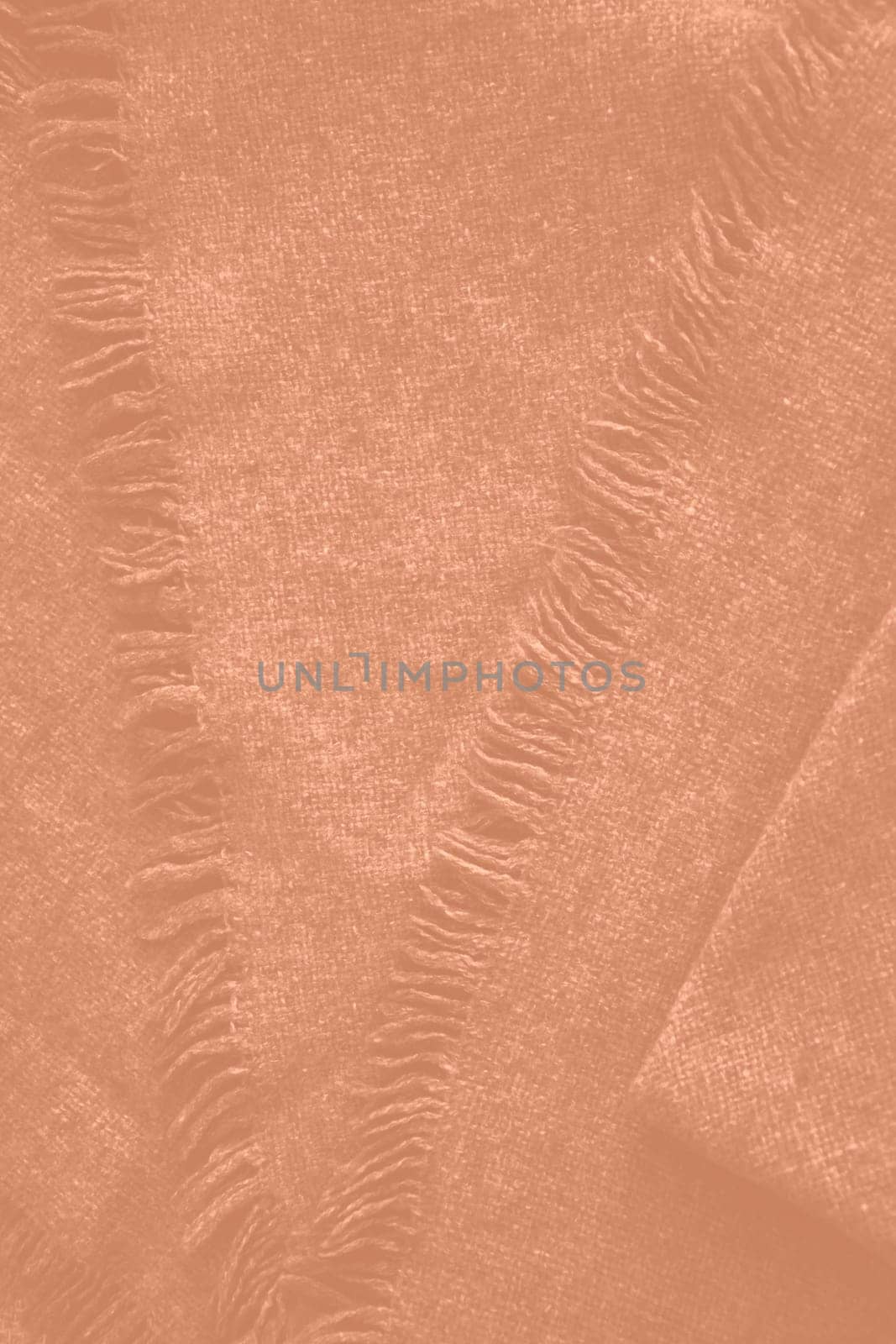 Peach fuzz colour monochrome texture knitted fabric. Peach knitted Jersey as textile background. Monochrome color background. Wool knitting texture. Trendy color 2024. High quality photo