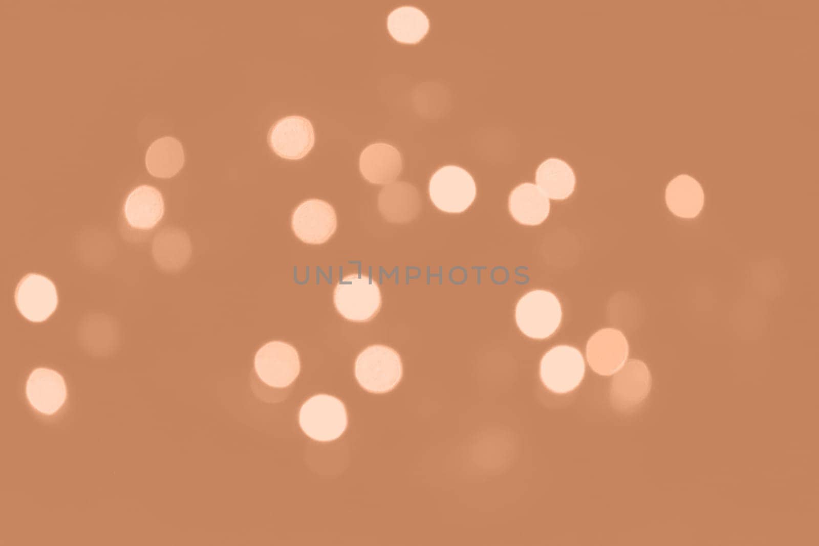Peach Fuzz lights bokeh background, Chrismas lights bokeh. Monochrome abstract background. Blurred and glowing lights. Classic blue bokeh lens effect from lighting spots. High quality photo