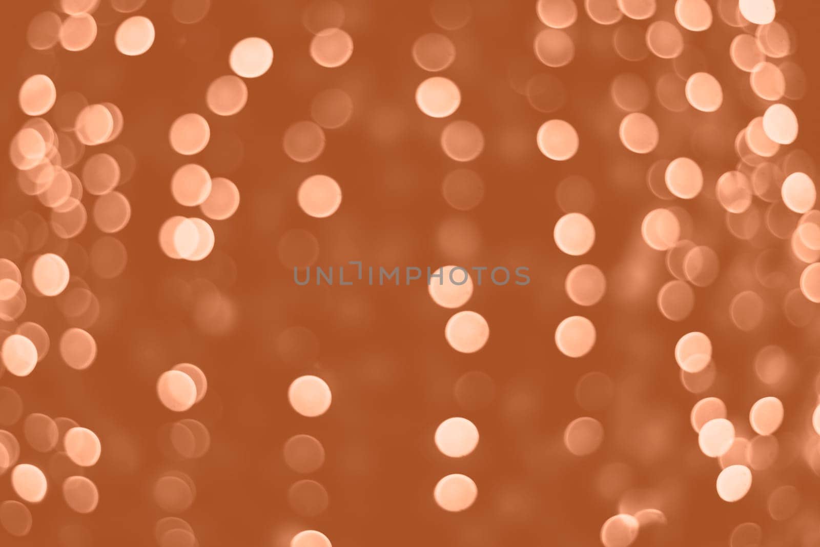 Peach Fuzz lights bokeh background, Chrismas lights bokeh. Monochrome abstract background. Blurred and glowing lights. Classic blue bokeh lens effect from lighting spots. High quality photo