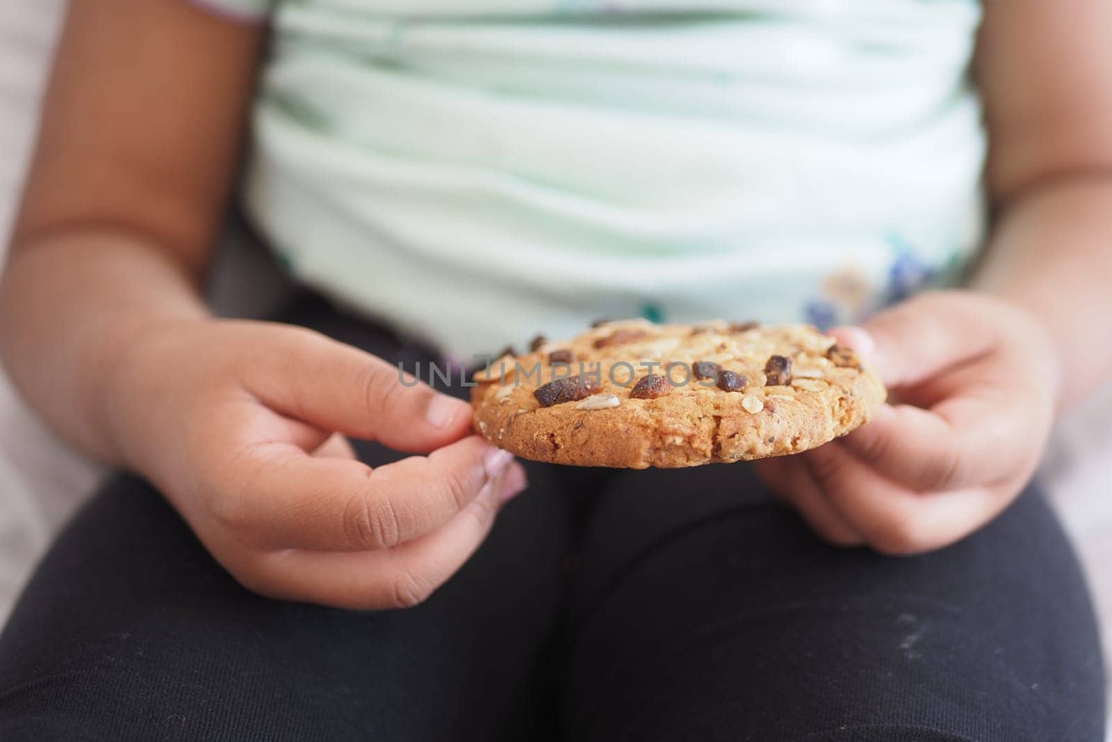 closeup of child eating whole meal cookies ,