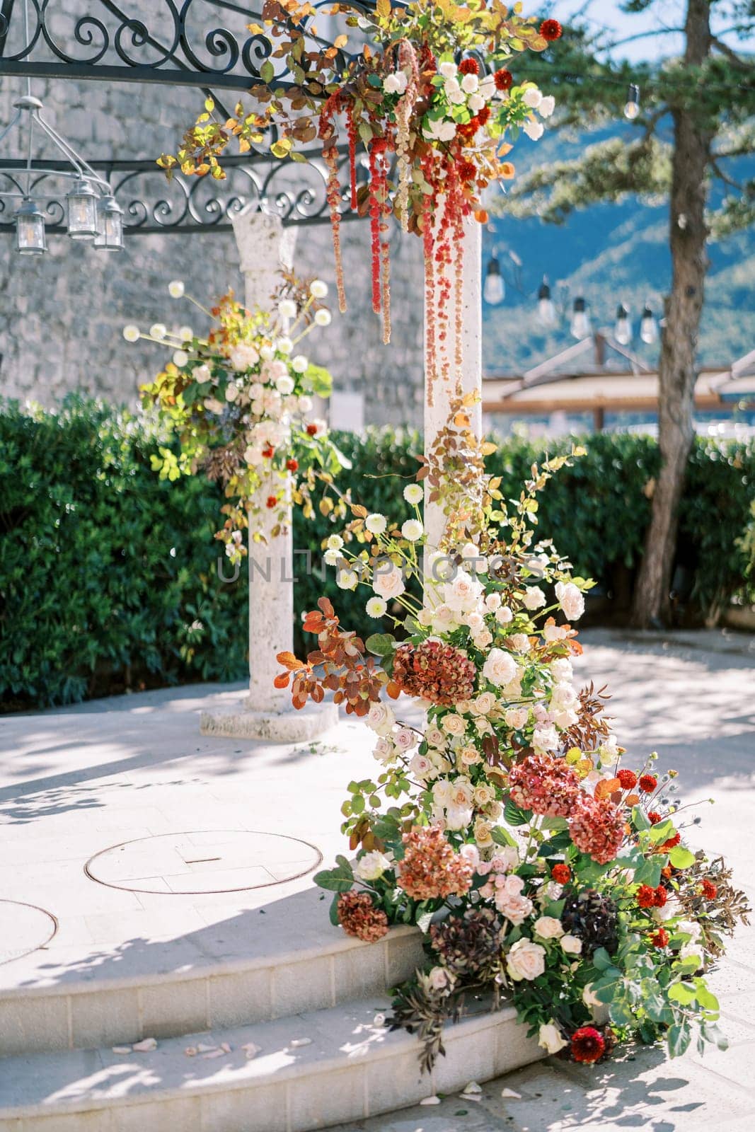 Wedding rotunda column covered with flowers. High quality photo