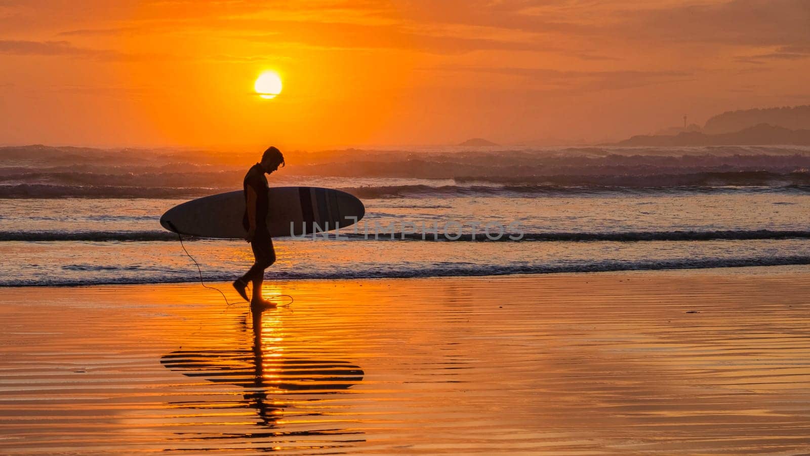 Tofino Beach Vancouver Island Pacific rim coast during sunset, surfers with surfboard during sunset at the beach of Tofino, surfers silhouette Canada Vancouver Island Tofino Long beach