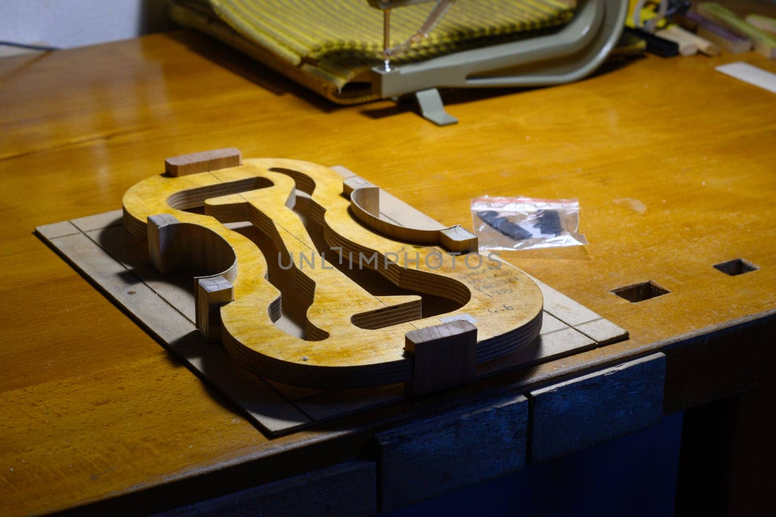 artisan violin maker luthier working on violin center bot, corner blocks , bend ribs for a new classic handmade violin by verbano