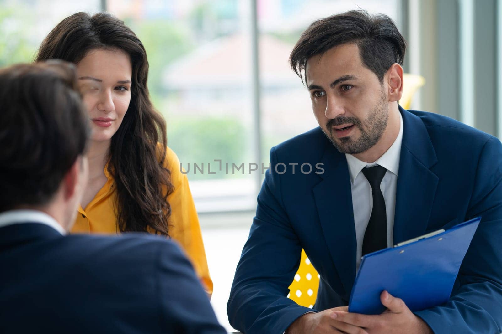 Diversity recruiters interview candidate at the bright office. A group of human resources professionals explaining an applicant for a new position. asking interviewee a question. Intellectual.