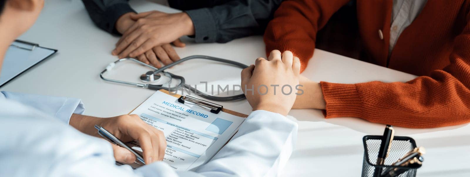 Couple attend fertility or medical consultation with gynecologist at hospital as family planning care for pregnancy while doctor and husband consoling young wife through appointment. Panorama Rigid