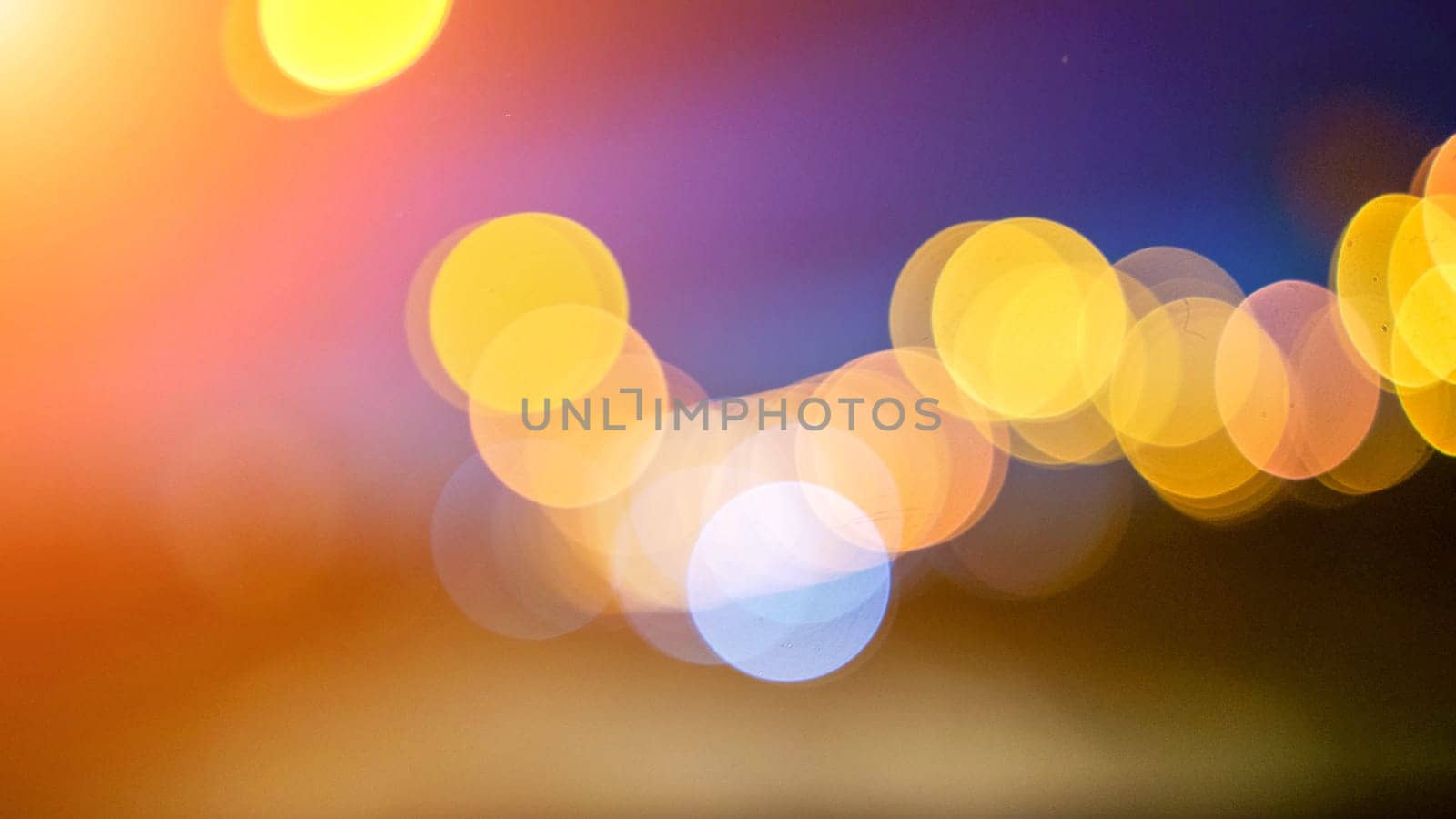 Blurred lights evening city traffic bokeh. Defocused night city traffic. Blurred lights bokeh car headlights driving evening city road. City night traffic background by Matiunina