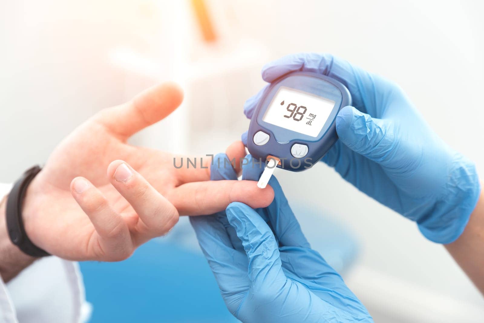 Doctor checking blood sugar level with glucometer by simpson33