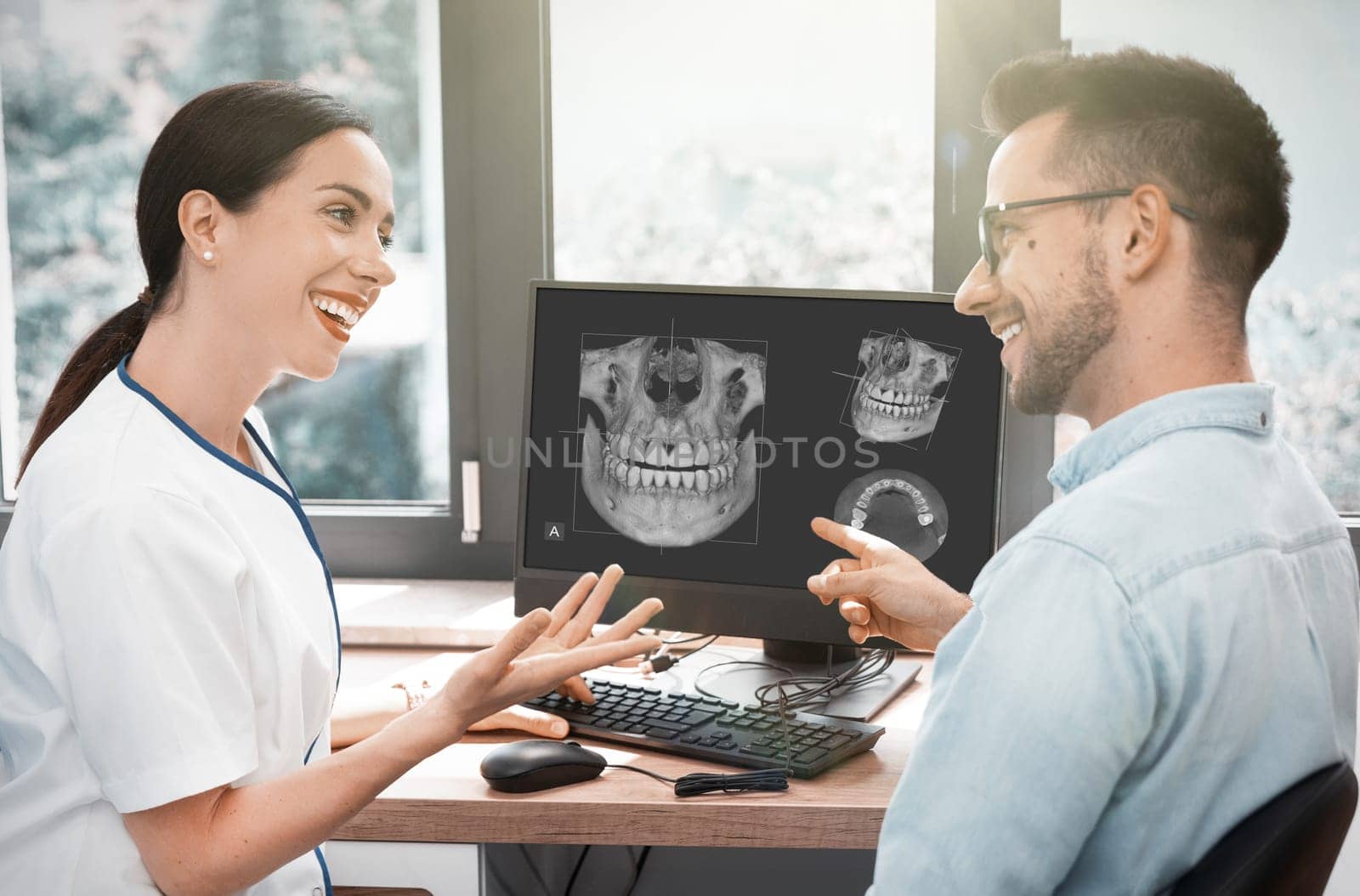 Dentist and patient consultation with x-ray image by simpson33