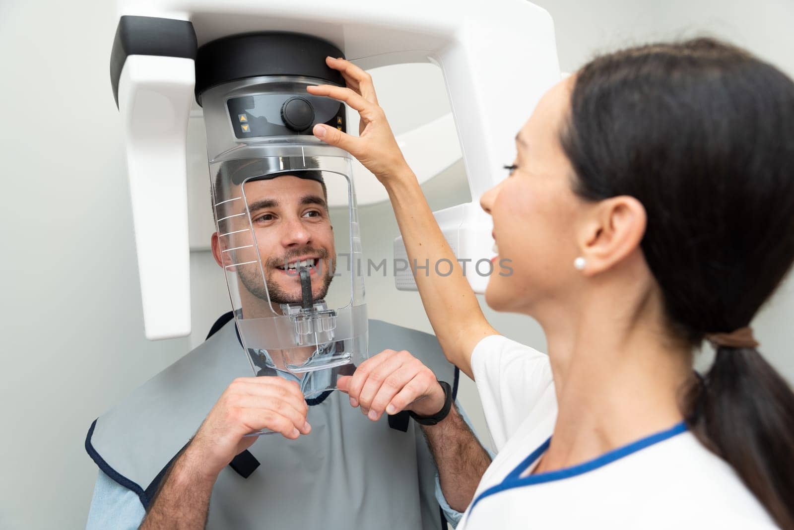 Patient standing in x-ray machine at dental clinic by simpson33