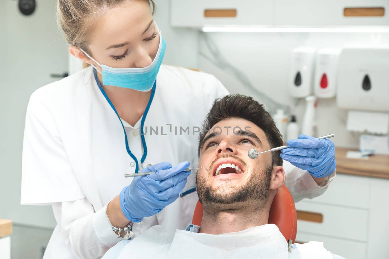 Man having teeth examined at dentists. Overview of dental caries prevention
