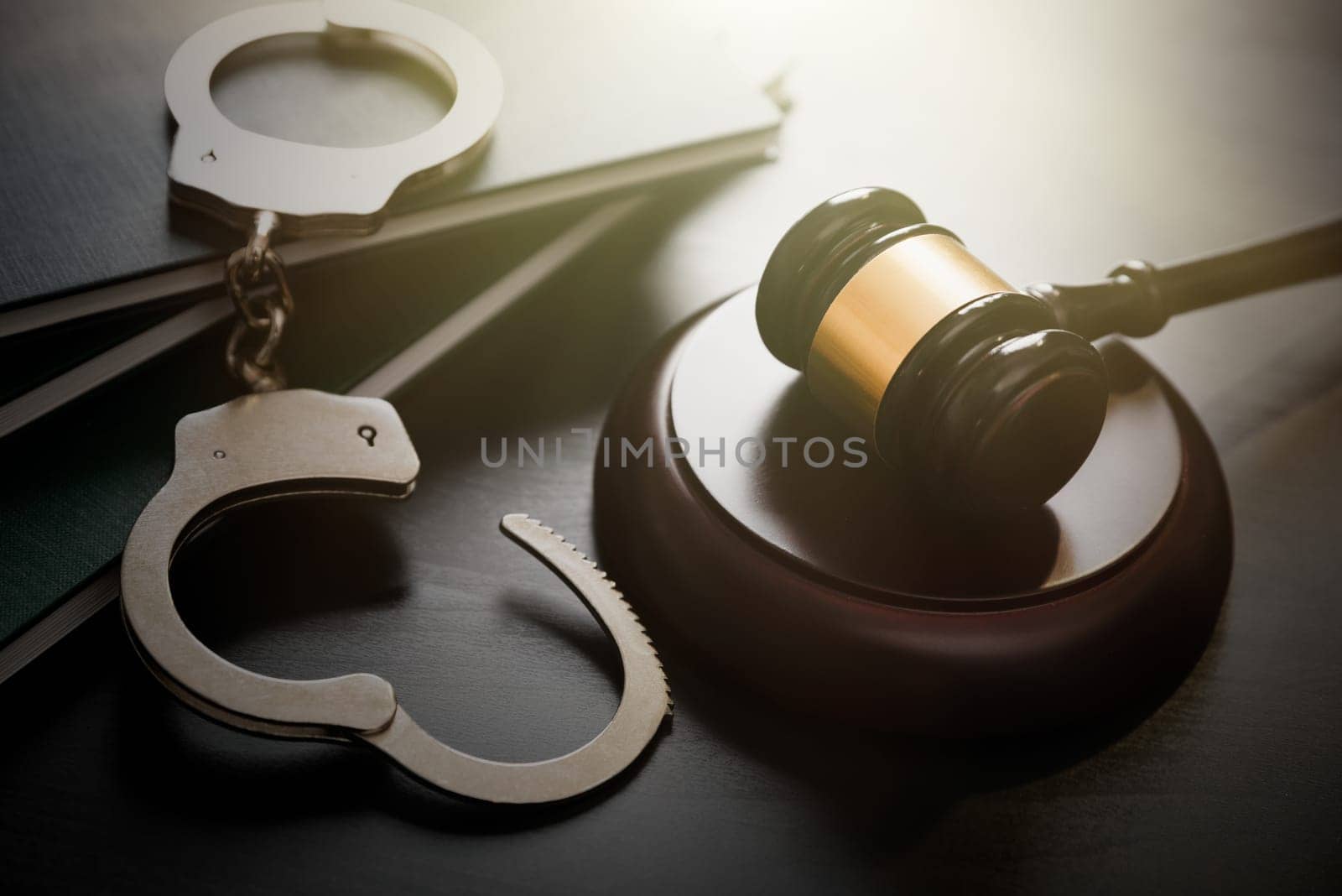 Handcuffs and wooden gavel. Crime and violence concept.