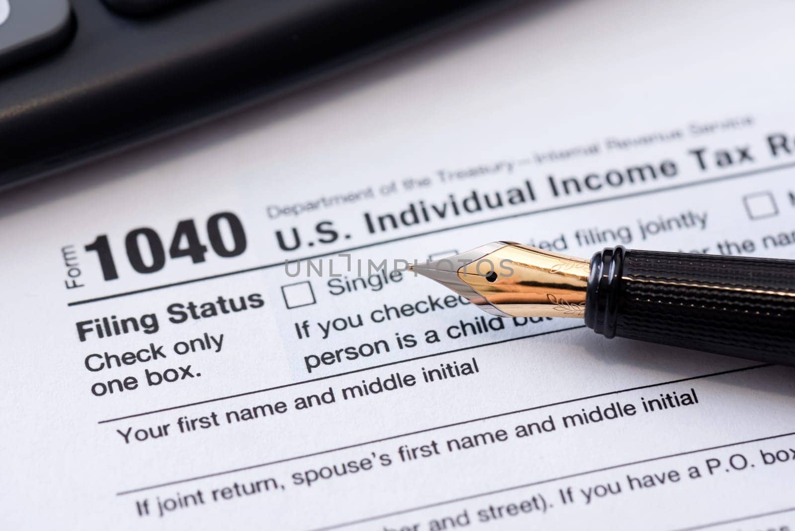 Tax return concept wits US 1040 tax form. Annual tax settlements