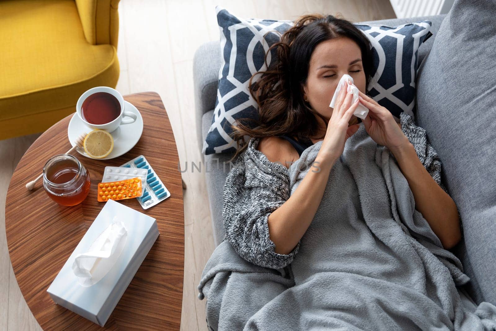 Sick woman in bed, blowing her nose, fever by simpson33