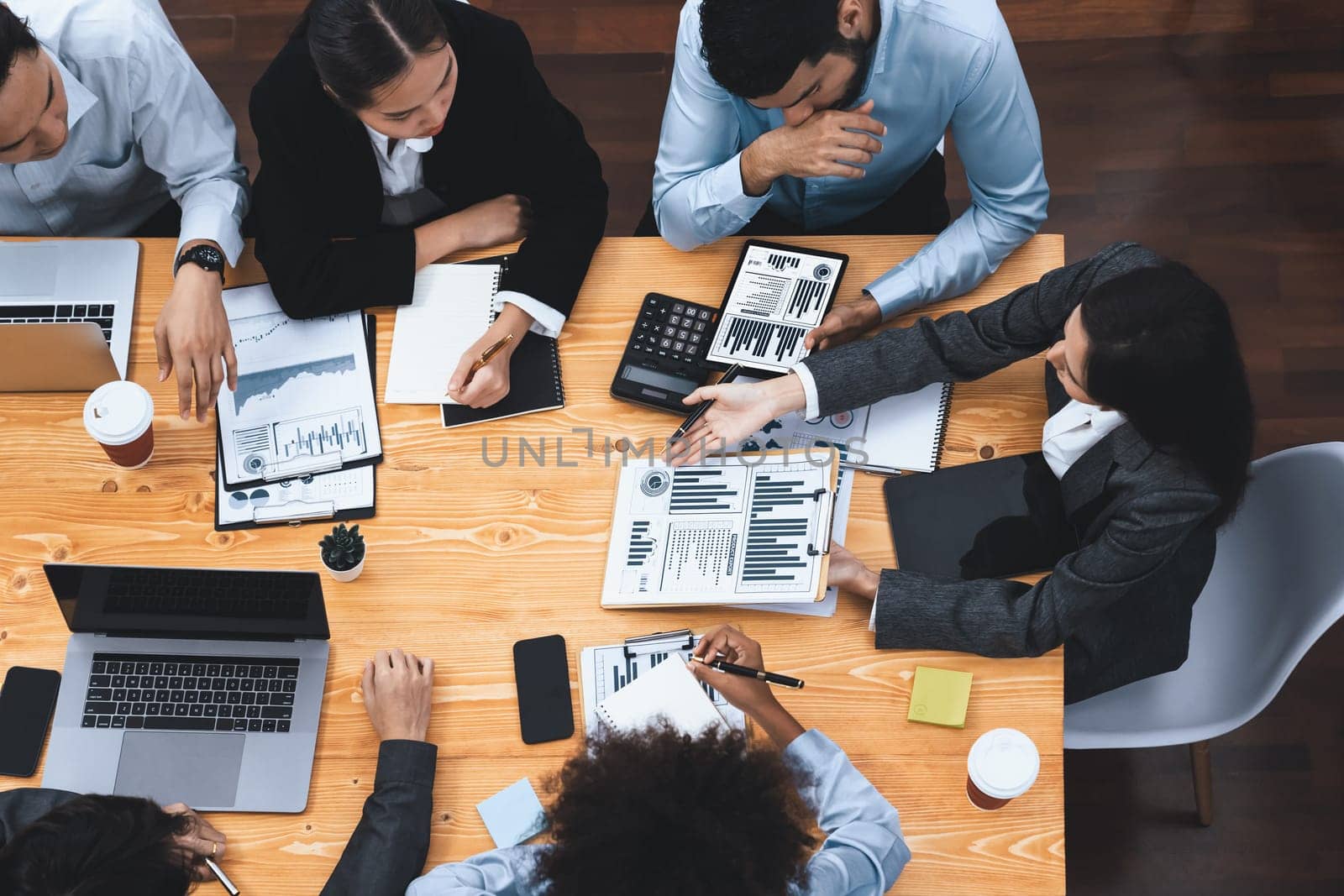 Top view multiracial analyst team use BI dashboard display on laptop screen, analyzing financial data for strategic decision. Fintech analyzes marketing indicators. Concord