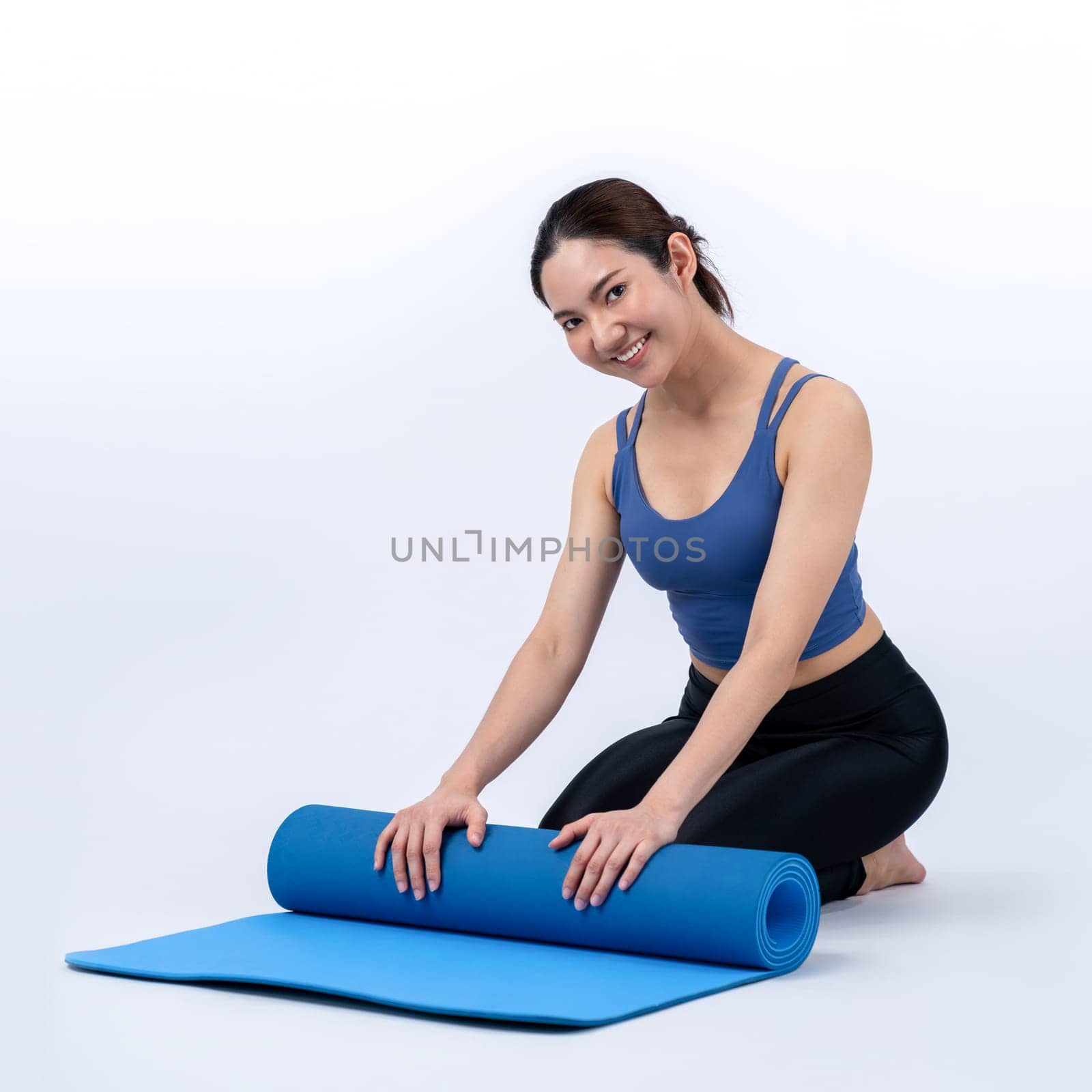 Young attractive asian woman portrait in sportswear with exercising mat Vigorous by biancoblue