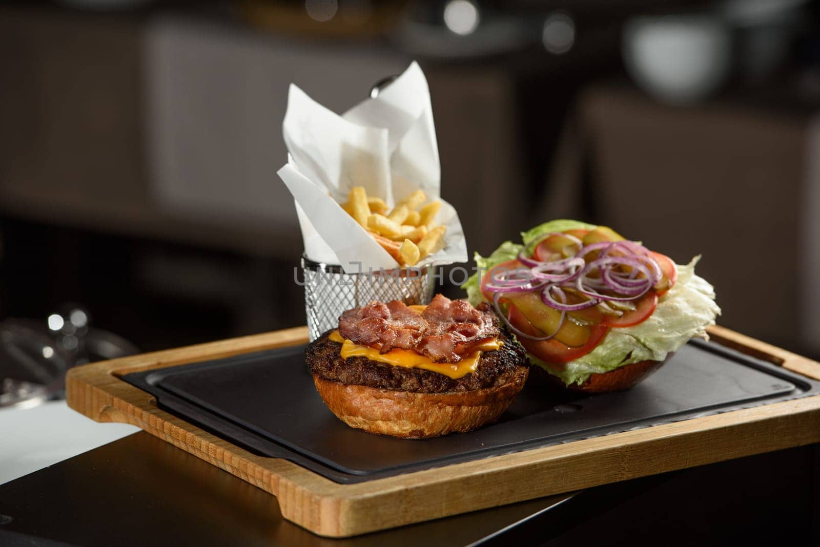 fresh tasty burger and french fries on wooden desk by Ashtray25