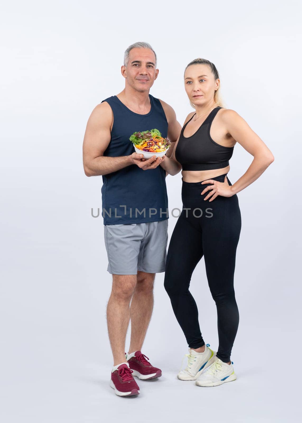 Happy smile senior man and woman portrait holding bowl of vegan. Clout by biancoblue