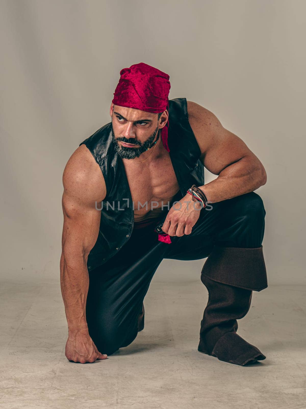 A Brave Soul in Crimson: A Male Bodybuilder with a Red Bandanna Standing Proudly Before a Clean Canvas by artofphoto