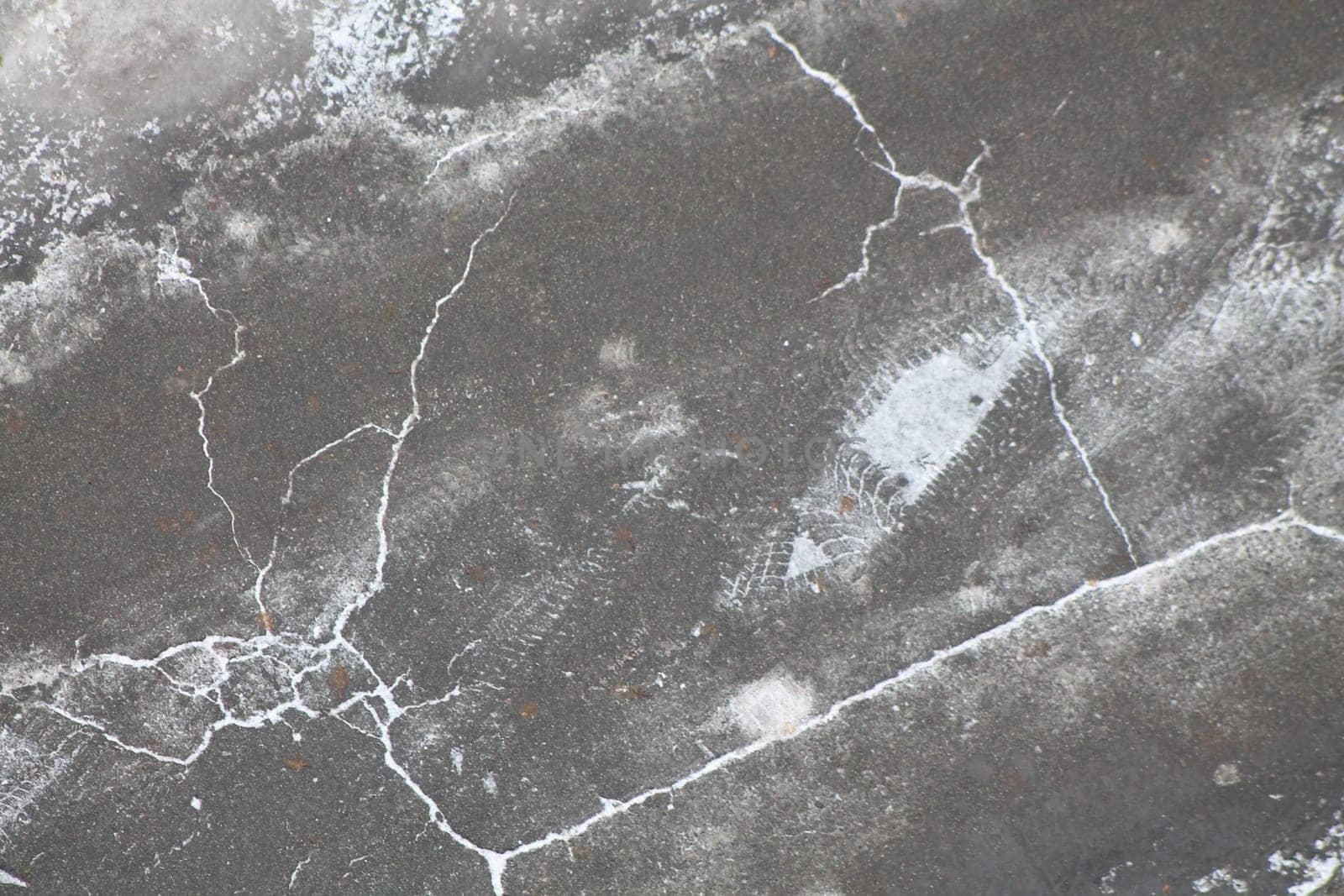 Cracked ice on the asphalt in the city by architectphd