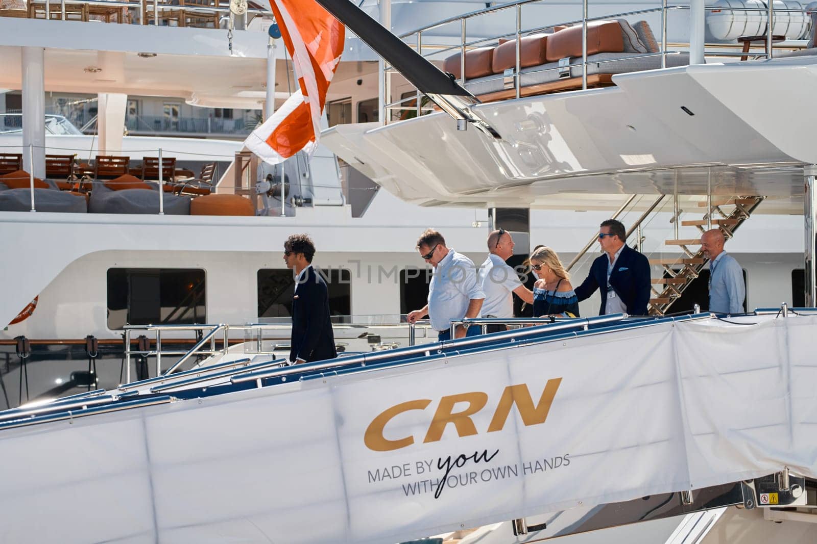 Monaco, Monte Carlo, 27 September 2022 - Invited wealthy clients inspect megayachts at the largest fair exhibition in the world yacht show MYS, port Hercules, yacht brokers, sunny weather. High quality photo