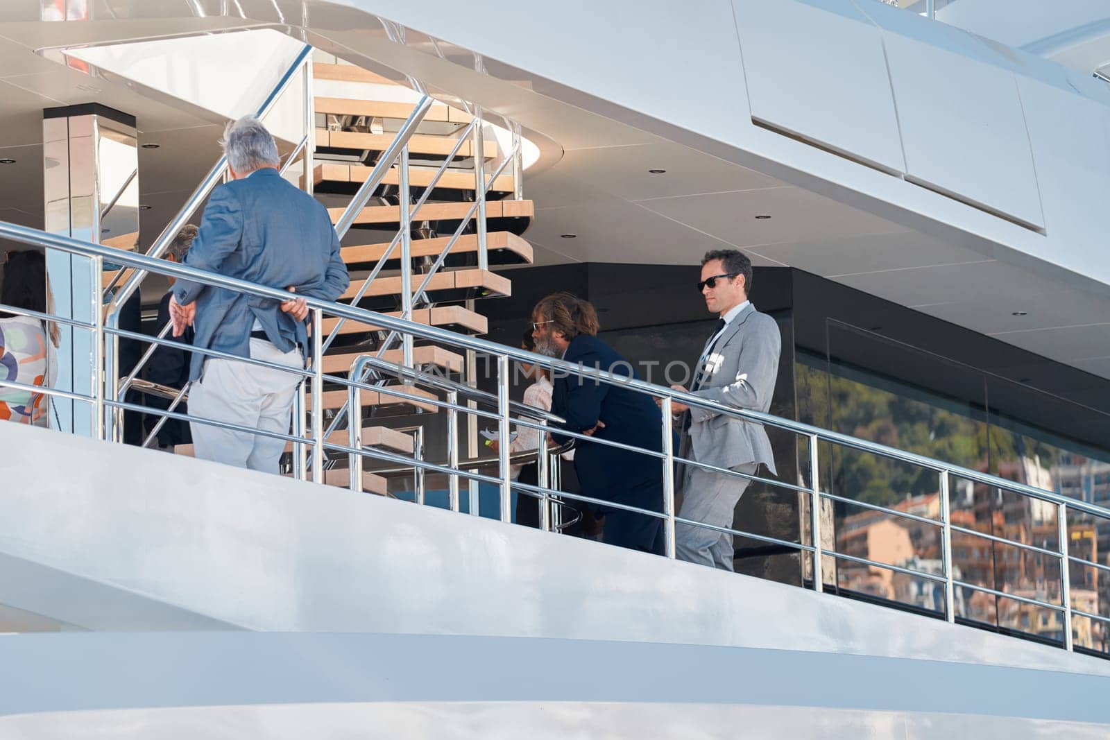 Monaco, Monte Carlo, 27 September 2022 - Invited wealthy clients inspect megayachts at the largest fair exhibition in the world yacht show MYS, port Hercules, yacht brokers, sunny weather. High quality photo