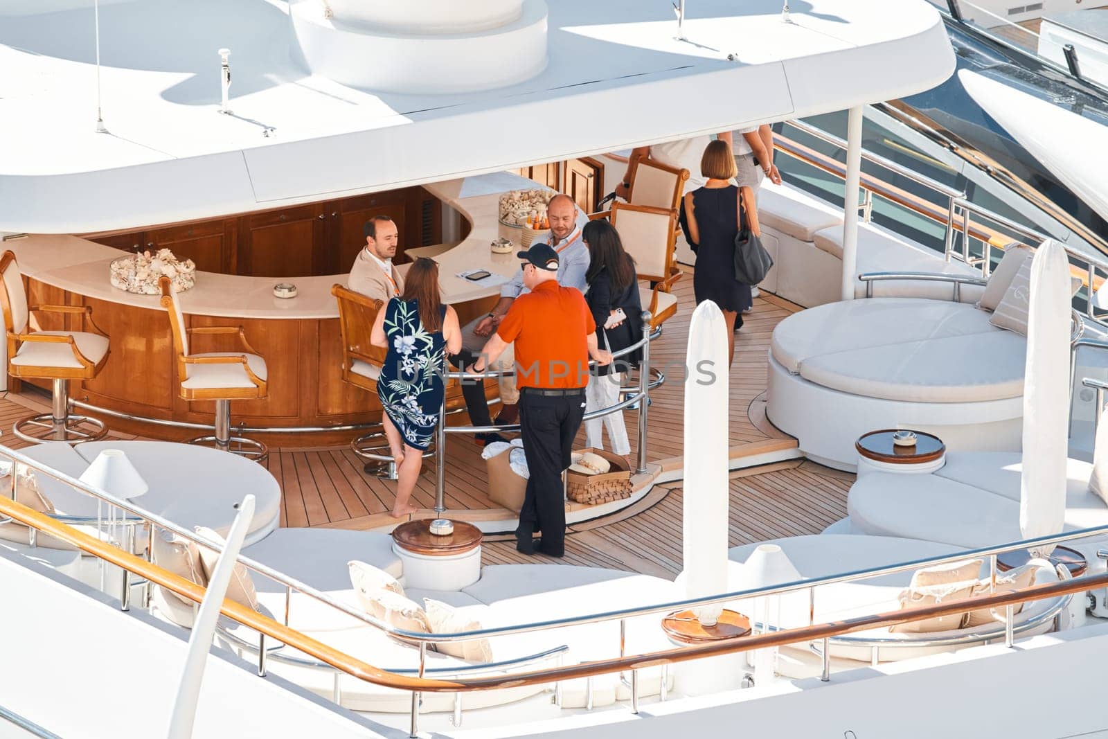 Monaco, Monte Carlo, 27 September 2022 - Invited wealthy clients inspect megayachts at the largest fair exhibition in the world yacht show MYS, port Hercules, yacht brokers, sunny weather. High quality photo