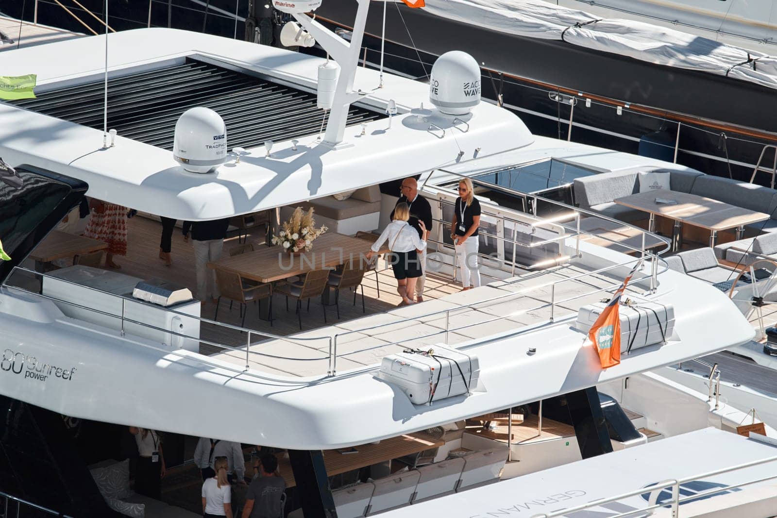 Monaco, Monte Carlo, 27 September 2022 - Invited wealthy clients inspect megayachts at the largest fair exhibition in the world yacht show MYS, port Hercules, yacht brokers, sunny weather. High quality photo