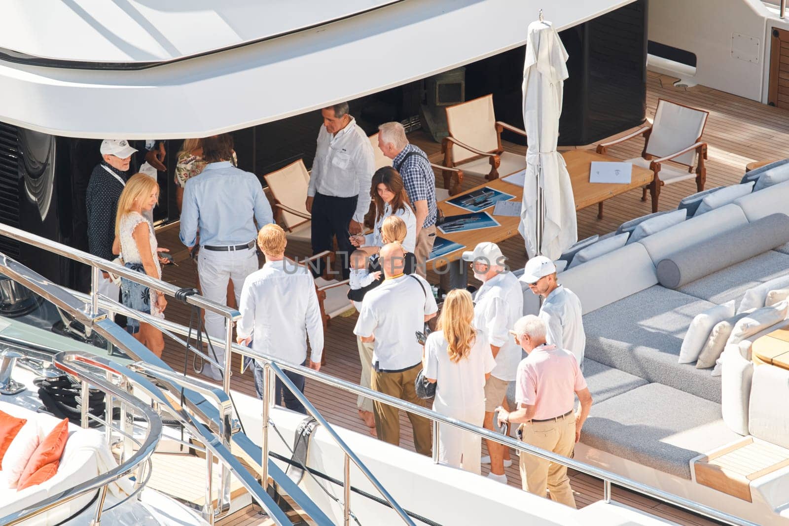 Monaco, Monte Carlo, 27 September 2022 - Invited wealthy clients inspect megayachts at the largest fair exhibition in the world yacht show MYS, port Hercules, yacht brokers, sunny weather. High quality photo