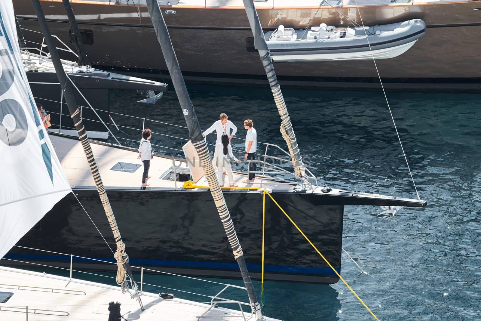 Monaco, Monte Carlo, 27 September 2022 - Invited wealthy clients inspect megayachts at the largest fair exhibition in the world yacht show MYS, port Hercules, yacht brokers, sunny weather. High quality photo