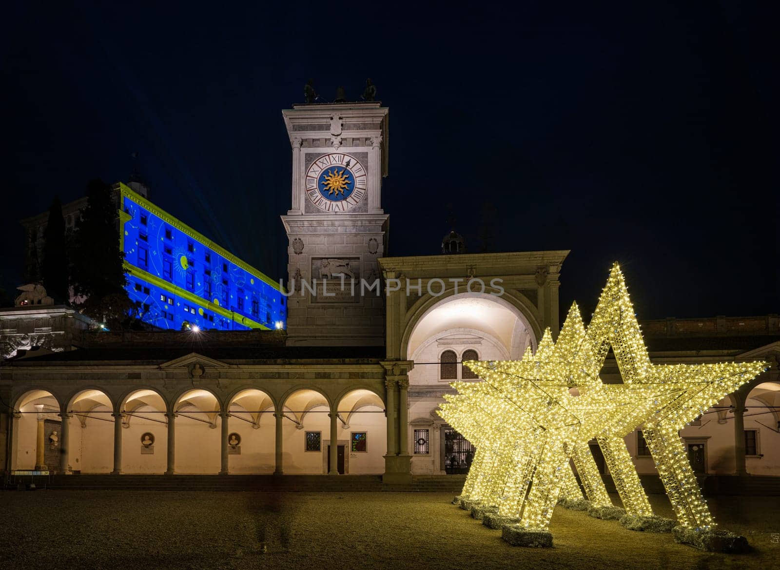 Udine, Italy, December 2023. the Christmas light decorations projected on the buildings of the historic center of the city