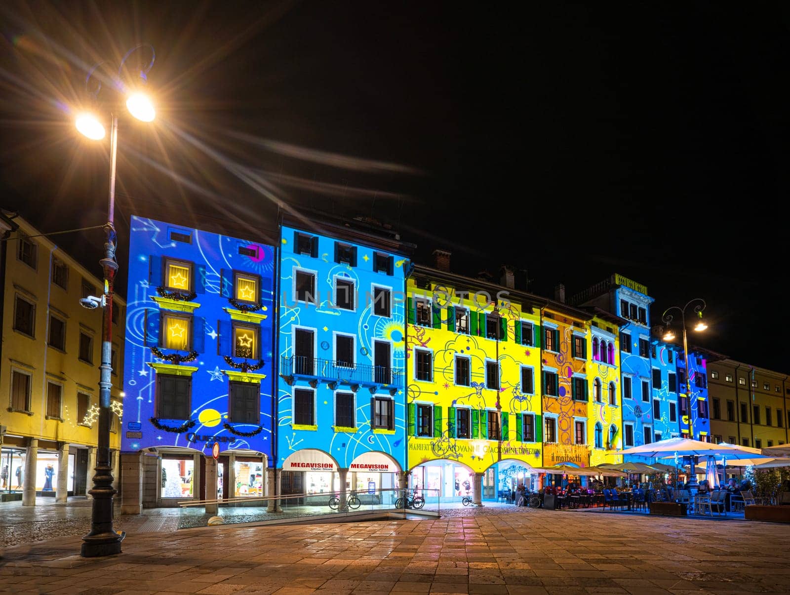 Udine, Italy, December 2023. the Christmas light decorations projected on the buildings of the historic center of the city