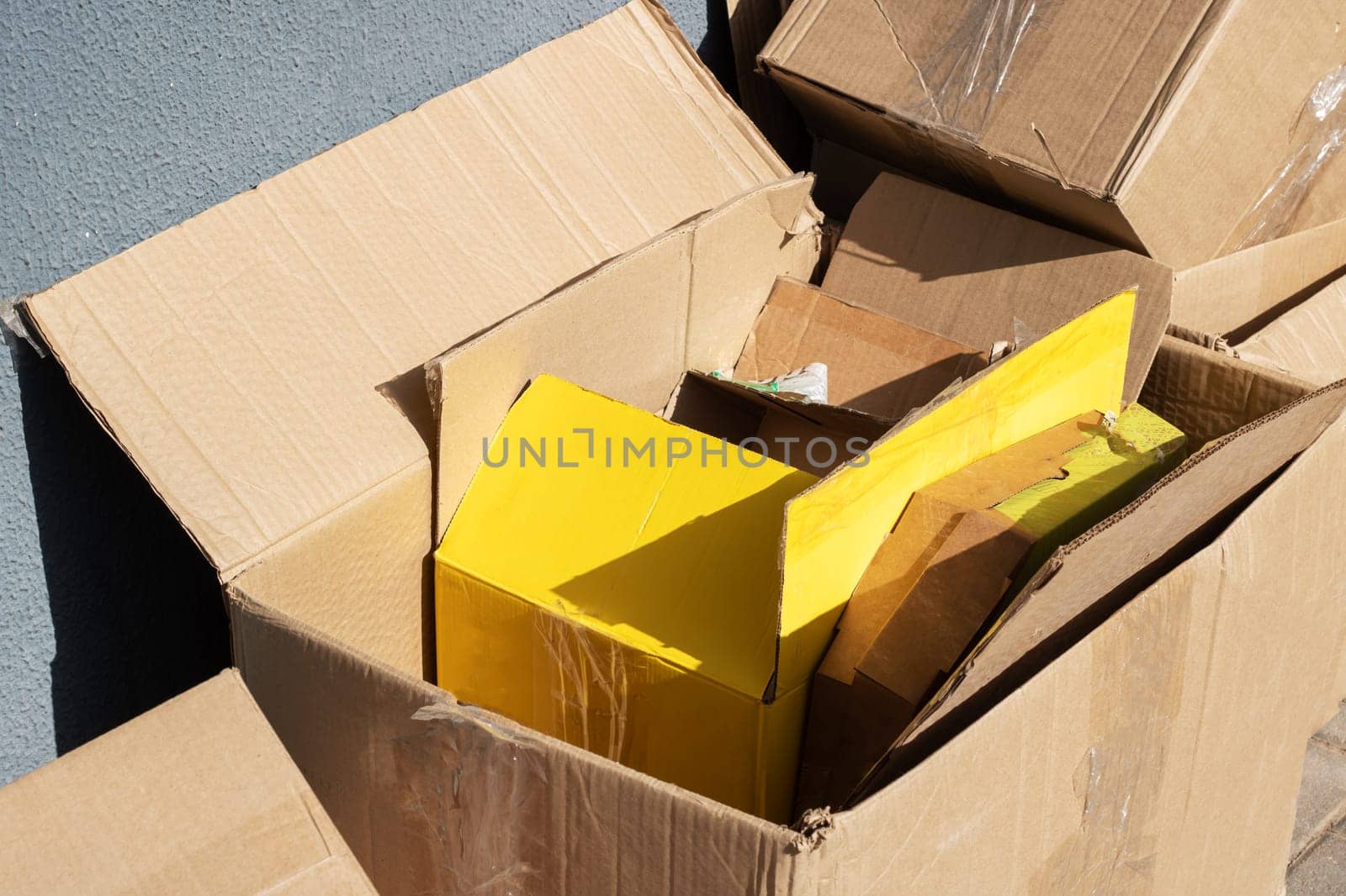 Empty cardboard boxes after moving close up in sunlight