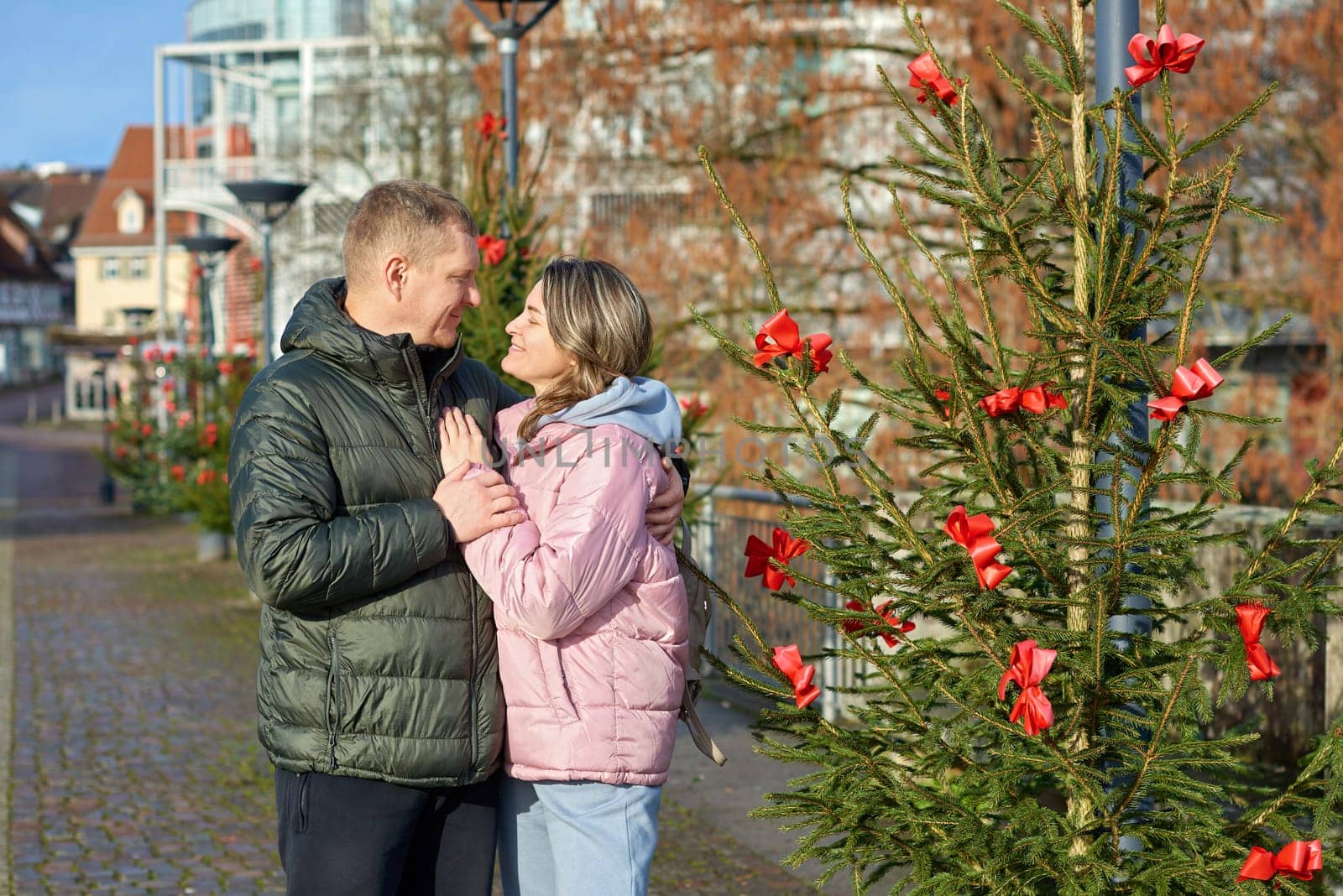 Romantic Christmas Stroll: Couple Embracing in the Charming Streets of Bietigheim-Bissingen, Germany