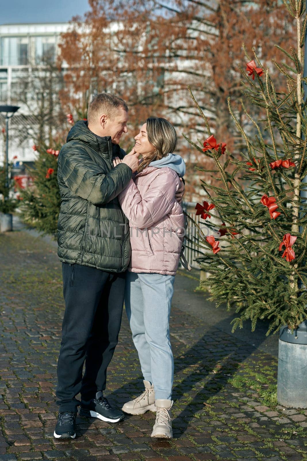 Romantic Christmas Stroll: Couple Embracing in the Charming Streets of Bietigheim-Bissingen, Germany