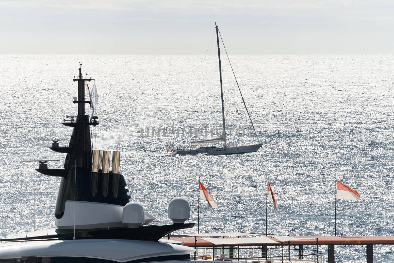 Monaco, Monte Carlo, 27 September 2022 - top of huge luxury yacht at sunny day, sailing yacht on background, the famous motorboat exhibition in the principality by vladimirdrozdin