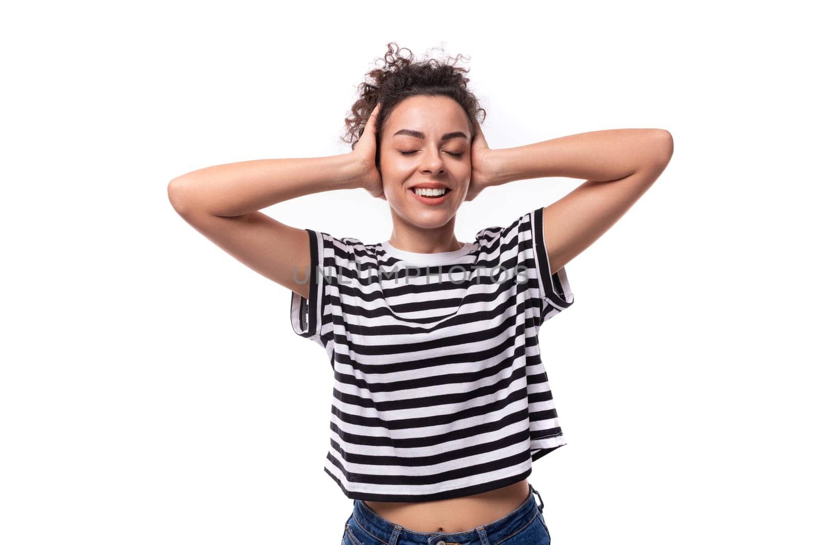 young cheerful curly brunette lady with black hair is dressed in a striped t-shirt by TRMK