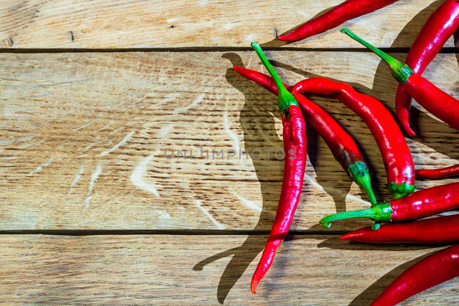Red hot peppers on wooden table by vladispas