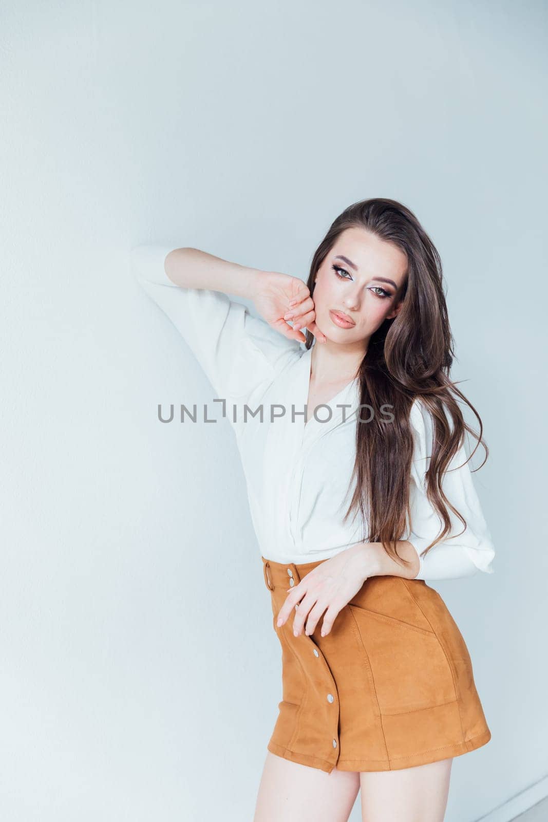 Beautiful fashionable woman in blouse and yellow skirt on white background
