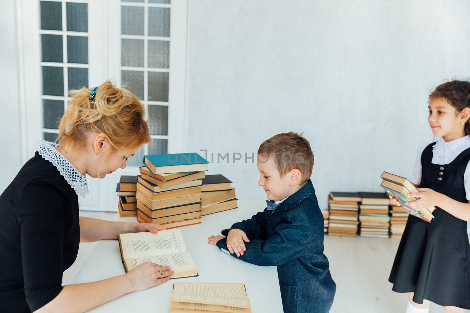 Teacher at lesson on teaching children in school classroom by Simakov