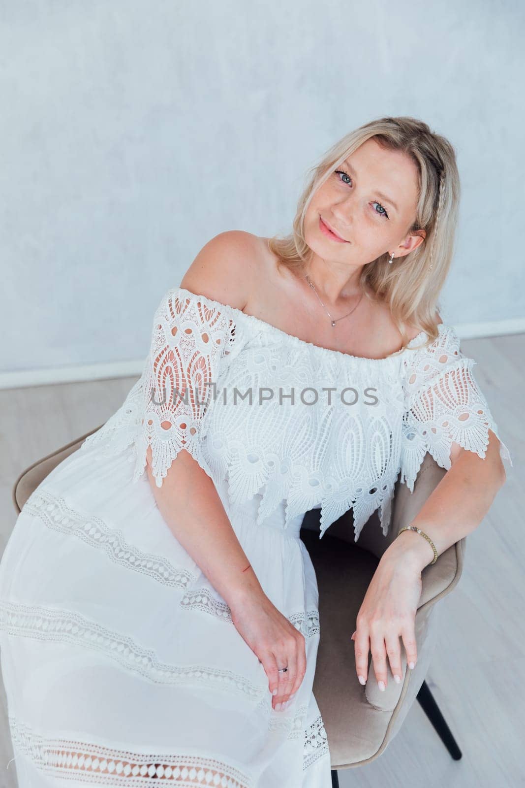 Portrait of a beautiful woman in a white summer dress